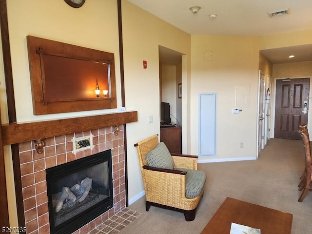 interior space with carpet flooring and a tile fireplace