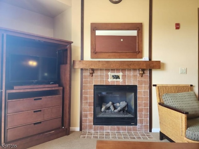 interior space with light colored carpet and a tiled fireplace