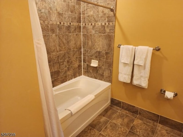 bathroom with tile patterned flooring and shower / bath combo with shower curtain