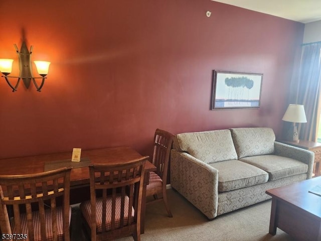 carpeted living room with a notable chandelier