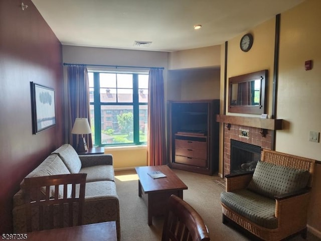 carpeted living room with a fireplace