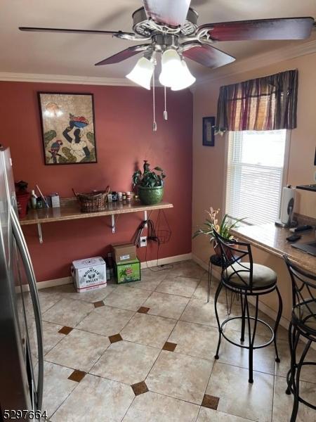 tiled office with crown molding and ceiling fan