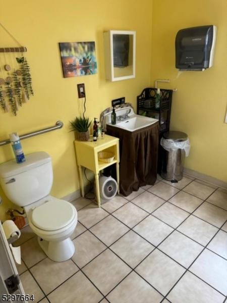 bathroom with tile patterned flooring, sink, and toilet