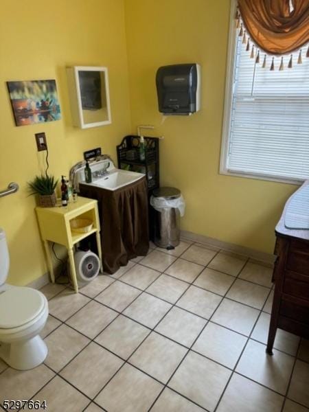 bathroom with tile patterned flooring and toilet