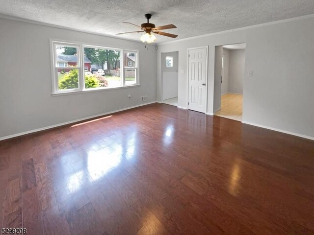 tiled spare room with a textured ceiling and ceiling fan