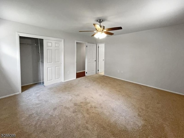 unfurnished bedroom featuring carpet flooring, a closet, and ceiling fan