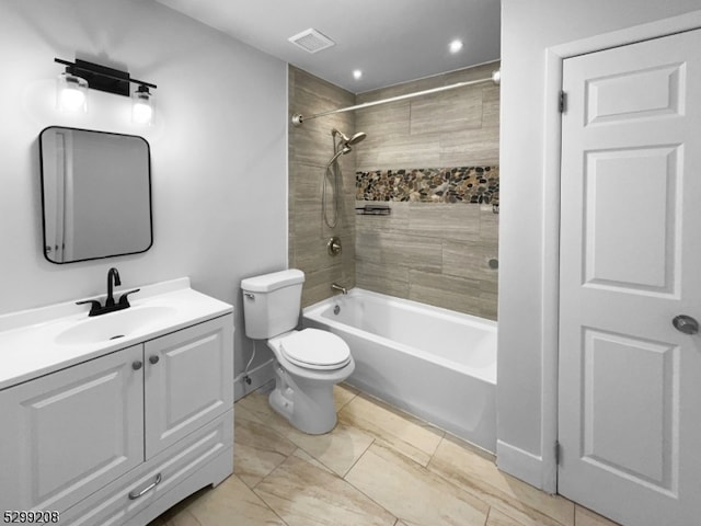 full bathroom with vanity, toilet, tiled shower / bath, and tile patterned floors