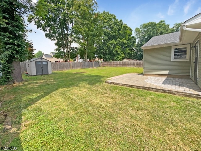 view of yard featuring a shed and a patio area