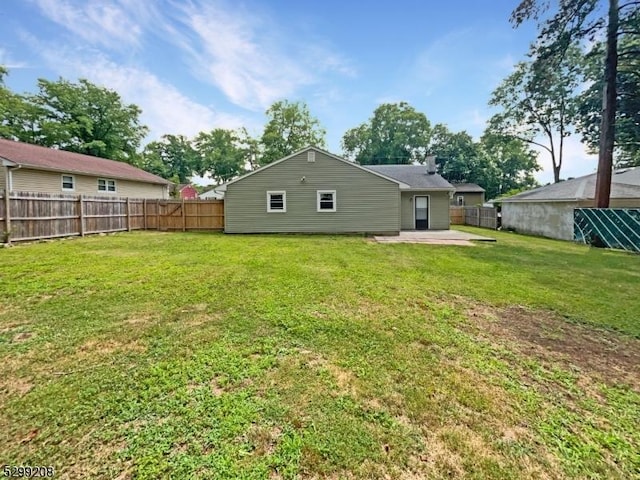 rear view of property featuring a patio area and a lawn