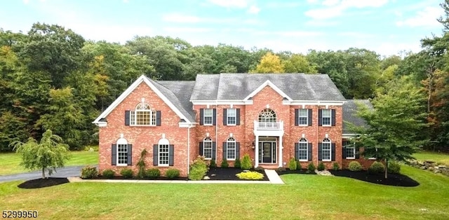 colonial inspired home with a front lawn