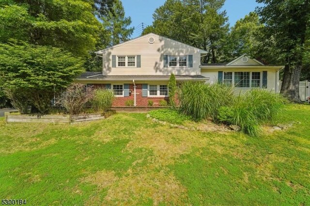 tri-level home with a front lawn