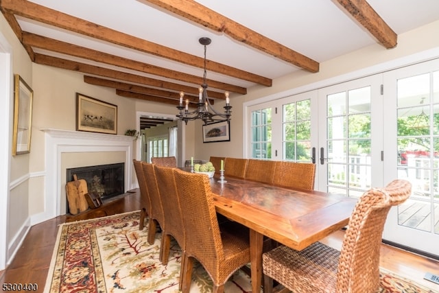 dining area featuring beamed ceiling, wood-type flooring, french doors, and a chandelier