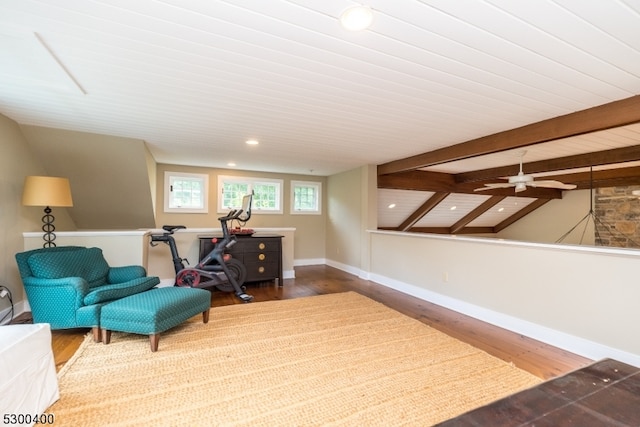 living area with vaulted ceiling with beams, ceiling fan, and hardwood / wood-style floors