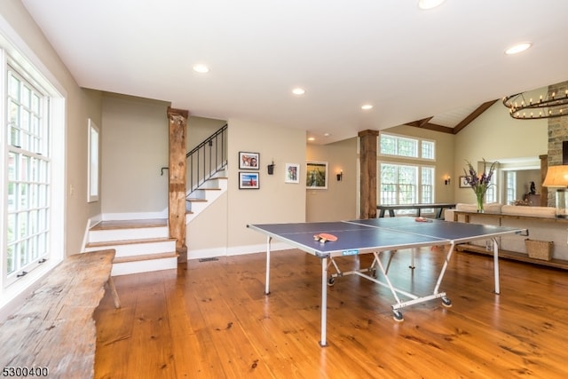 game room with wood-type flooring and vaulted ceiling