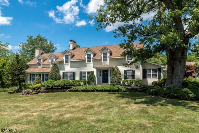 new england style home with a front yard