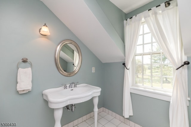 bathroom with tile patterned flooring and lofted ceiling