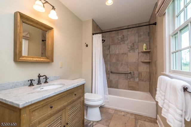 full bathroom featuring tile patterned floors, shower / bathtub combination with curtain, toilet, and vanity