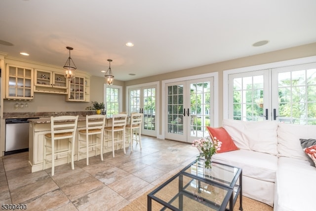 tiled living room featuring french doors and a wealth of natural light