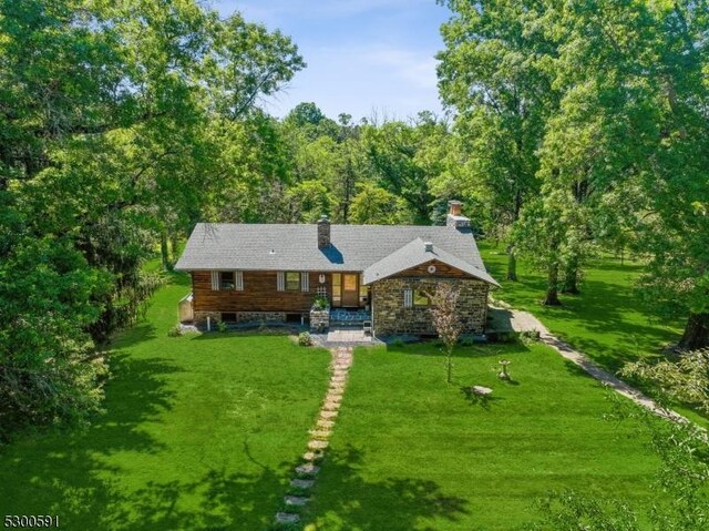 back of property featuring a lawn