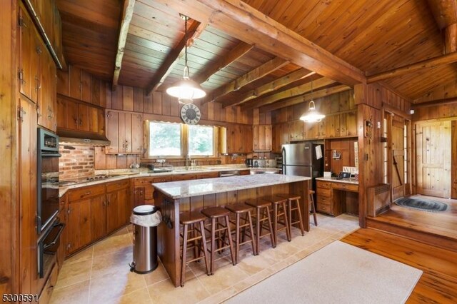 kitchen featuring wood ceiling, a kitchen island, and light tile patterned floors