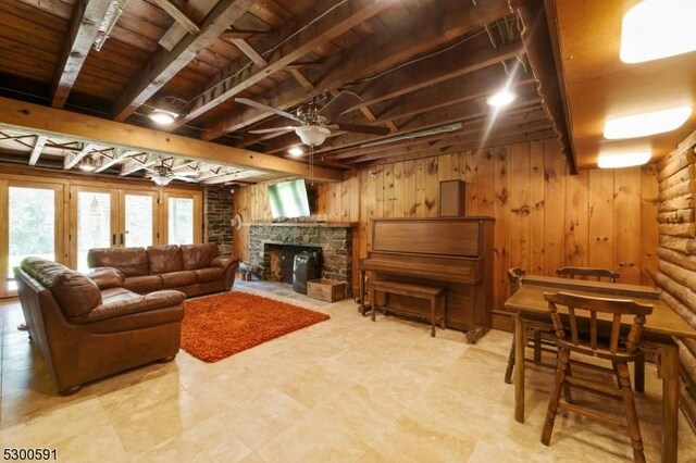 tiled living room featuring a stone fireplace, french doors, wood ceiling, and ceiling fan