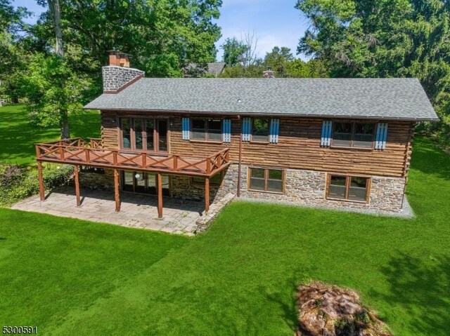 rear view of house with a patio area, a yard, and french doors