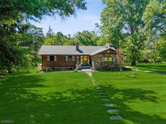 rear view of property with a patio and a lawn