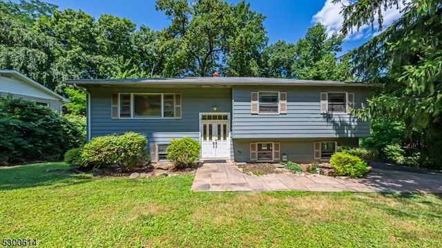 raised ranch featuring a front yard