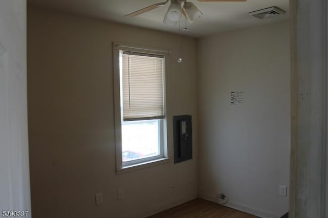 spare room featuring wood-type flooring and ceiling fan