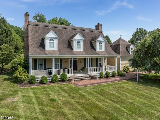 cape cod home featuring a chimney, a front lawn, and a porch