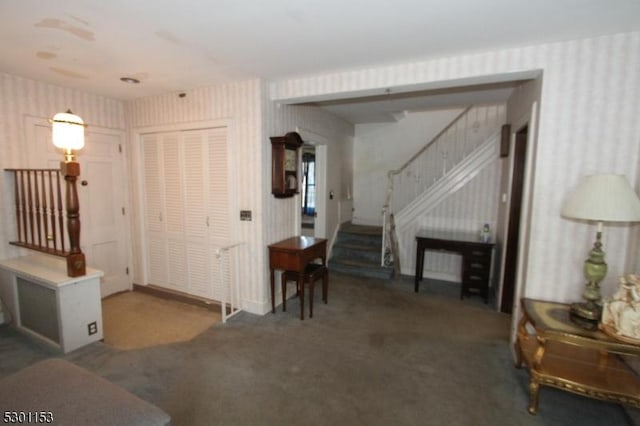 foyer with dark carpet