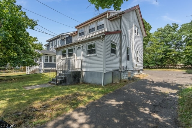 rear view of property featuring a yard