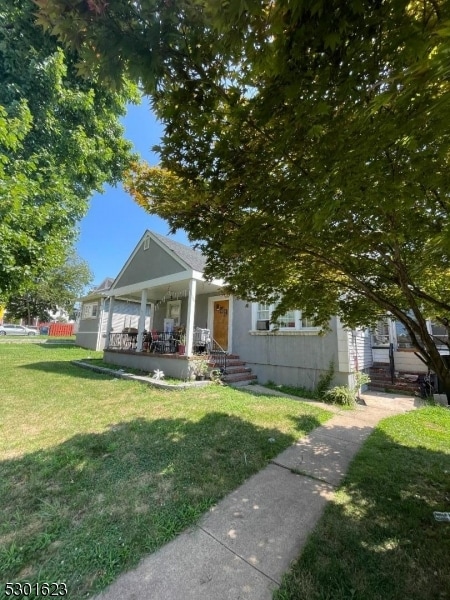 view of front of property with a porch and a front lawn