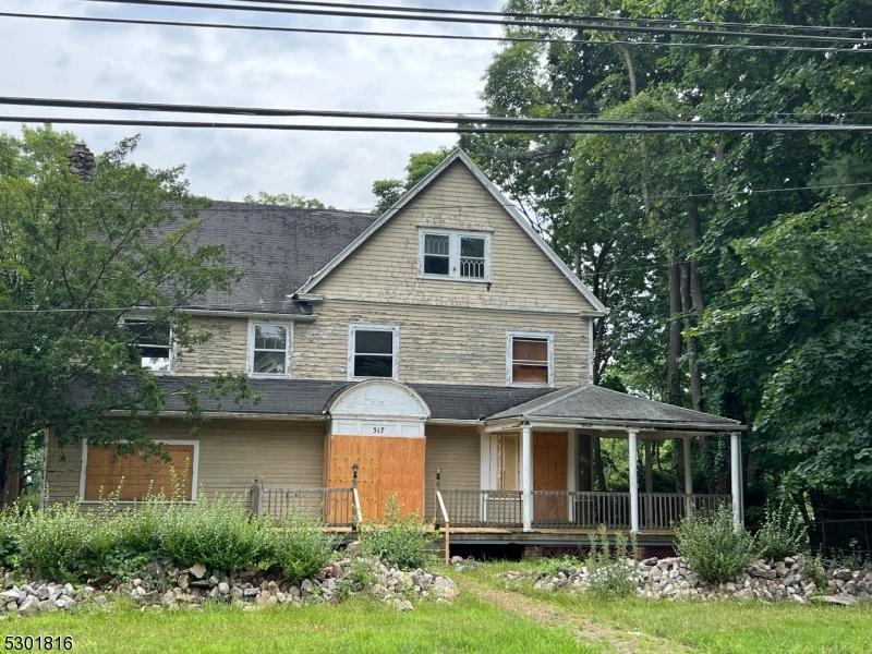 view of front of home with a porch and a garage