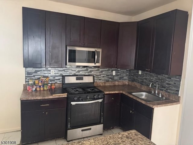 70 Campfield St, Irvington Twp, NJ 07111 - kitchen with a sink, tasteful backsplash, appliances with stainless steel finishes, and light tile patterned floors