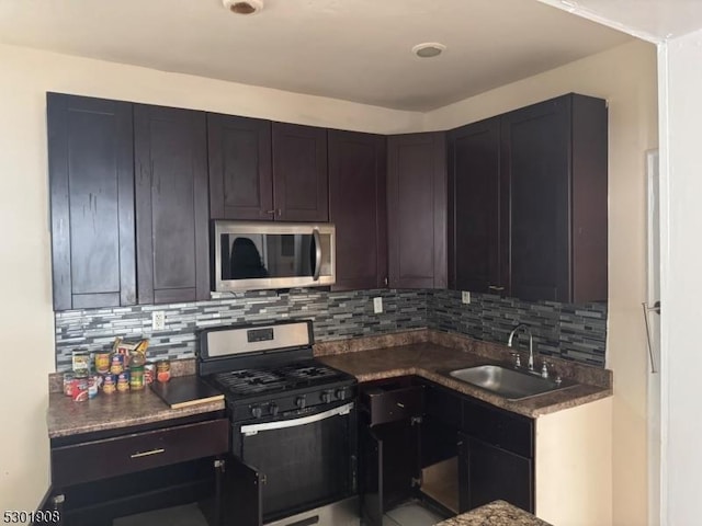 70 Campfield St, Irvington Twp, NJ 07111 - kitchen featuring backsplash, a sink, dark countertops, and appliances with stainless steel finishes