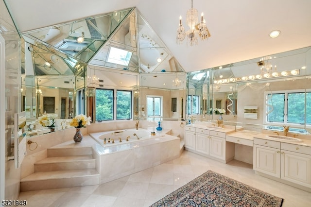 bathroom with vanity, tiled bath, tile patterned floors, and plenty of natural light