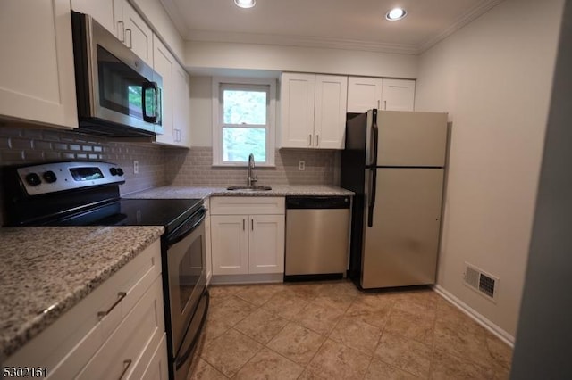 203 Jamestown Rd, Bernards Twp, NJ 07920 - kitchen featuring appliances with stainless steel finishes, a sink, crown molding, backsplash, and white cabinetry