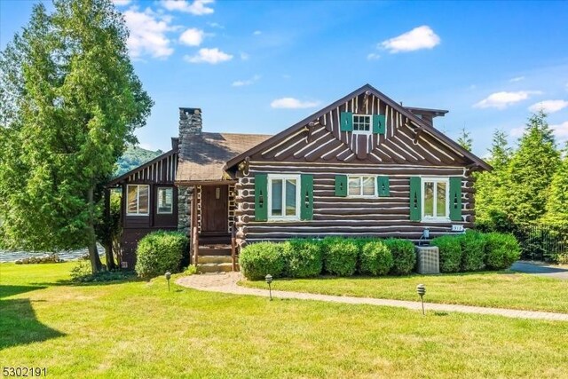 log-style house with a front yard