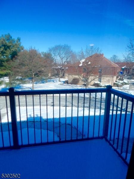 view of snow covered back of property