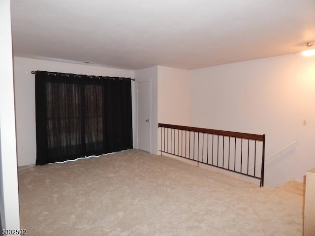 empty room featuring light carpet