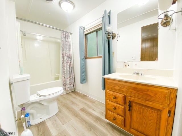 full bathroom featuring vanity, shower / tub combo, hardwood / wood-style flooring, and toilet