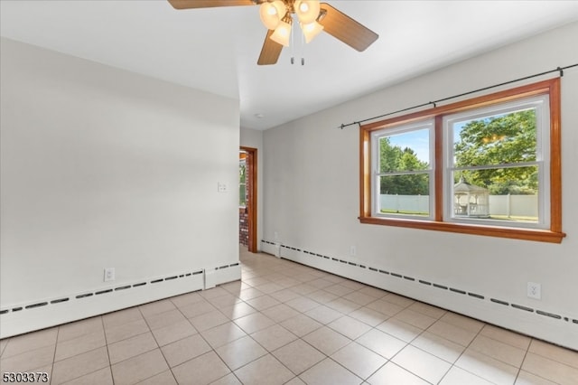 empty room with ceiling fan, light tile patterned floors, and a baseboard heating unit