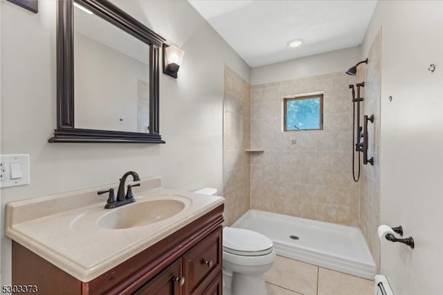 bathroom featuring a baseboard heating unit, tile patterned floors, tiled shower, vanity, and toilet