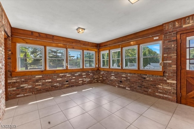 unfurnished sunroom with plenty of natural light