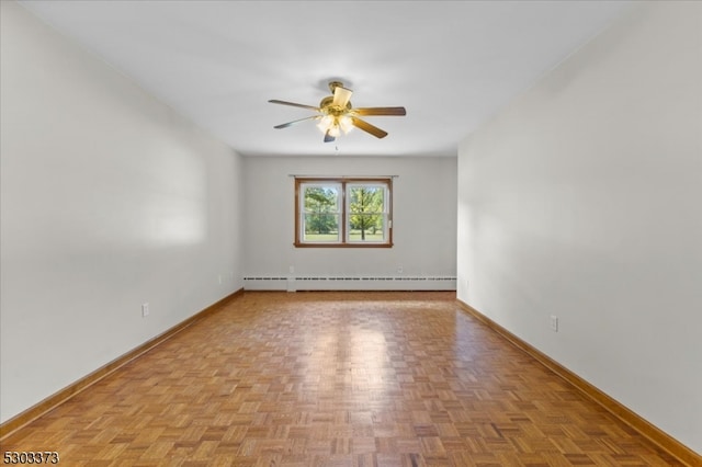 spare room featuring a baseboard radiator, ceiling fan, and light parquet floors