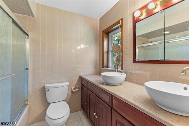 full bathroom featuring tile walls, tile patterned flooring, vanity, and toilet