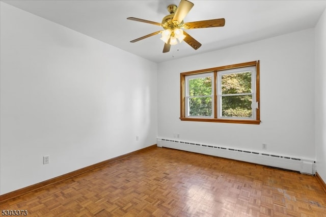 empty room with parquet flooring, ceiling fan, and a baseboard radiator