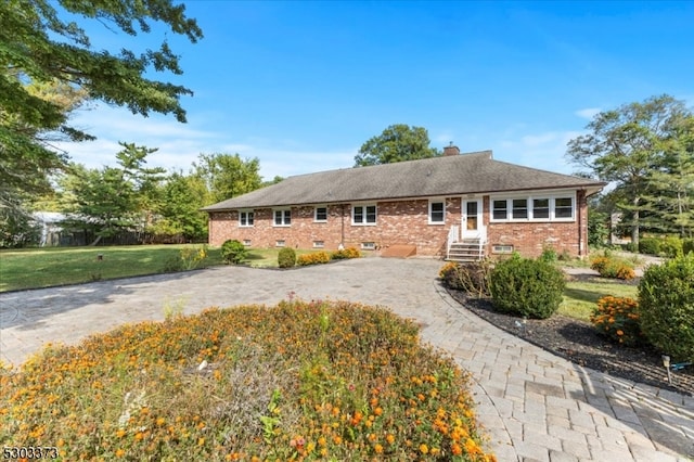 ranch-style home with a front lawn