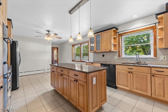 kitchen featuring ceiling fan, black dishwasher, a healthy amount of sunlight, and a kitchen island